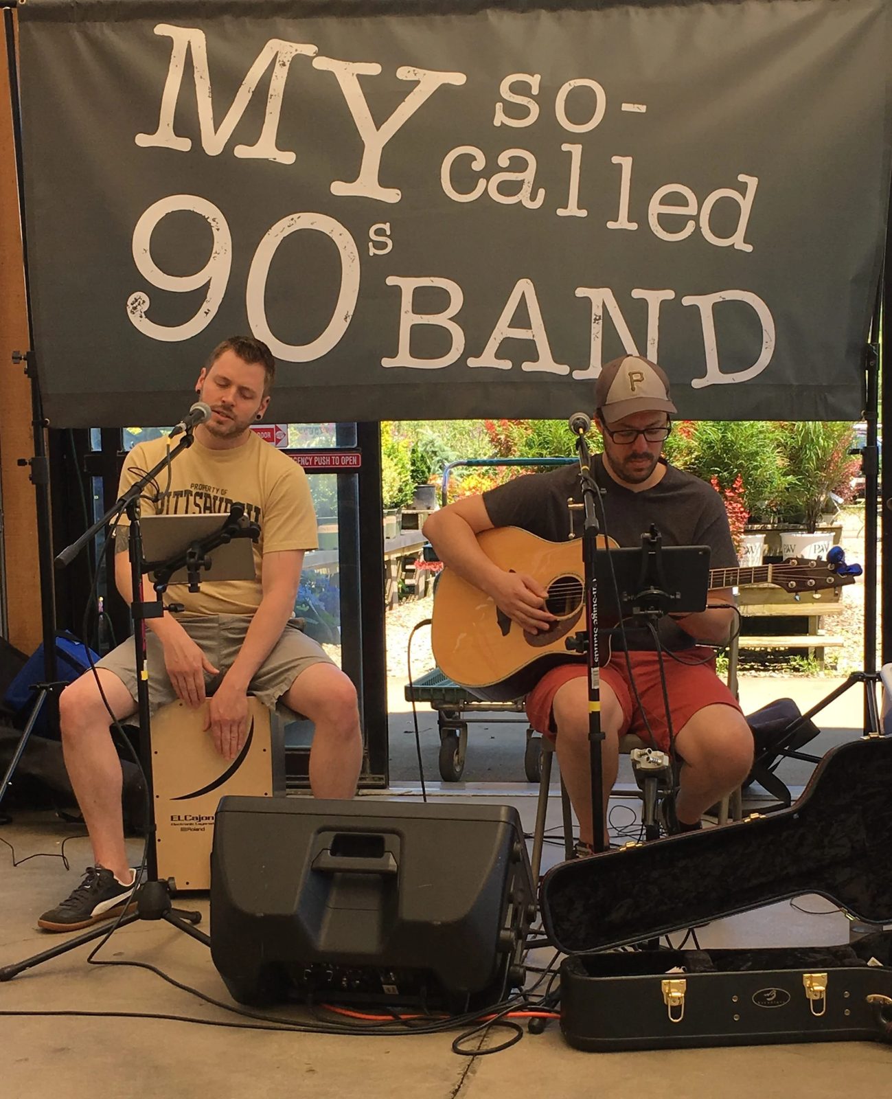 Acoustic duo with the band banner