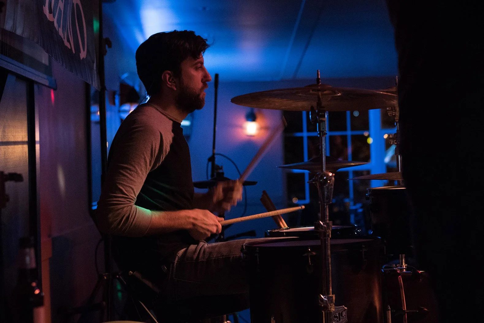 Drums under blue and purple lighting